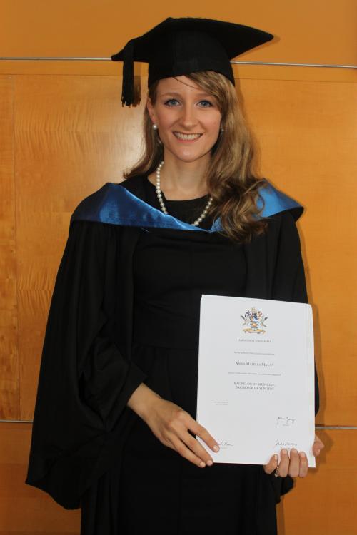 AMA Queensland Foundation James Cook University bursary recipient Anna Malan ,wearing graduation robes, holds her Bachelor of Medicine, Bachelor of Surgery degree.